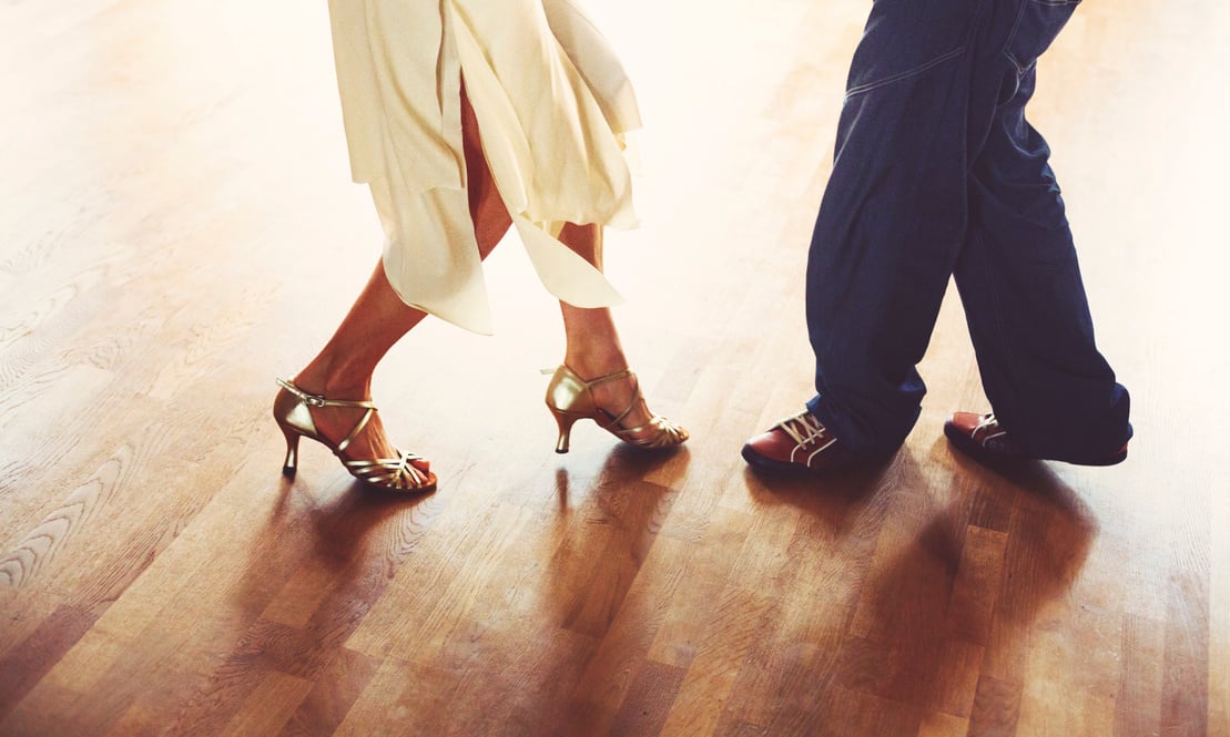 Dancing couple in the light dance hall