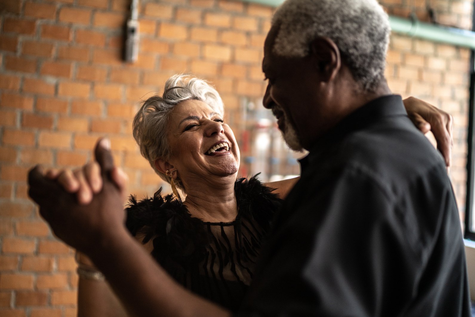 Senior couple dancing waltz in dance hall